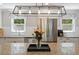 Granite island with seating. Modern stainless appliances and traditional window treatments in this well-lit kitchen at 1008 Winona Rd, Raleigh, NC 27609