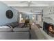 Spacious living room featuring a cozy fireplace, light blue walls, and an expansive gray sectional sofa with stylish decor at 1008 Winona Rd, Raleigh, NC 27609