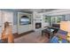 Comfortable living room with a fireplace, built-in shelving, and a cozy seating area with a gray sectional couch at 1008 Winona Rd, Raleigh, NC 27609