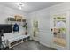 Practical mud room featuring a bench with storage, a coat rack, and a glass-paneled door to the outdoors at 1008 Winona Rd, Raleigh, NC 27609