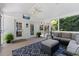 Relaxing sunroom is furnished with comfy seating, ceiling fan, and outdoor access at 1008 Winona Rd, Raleigh, NC 27609