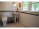 Bright bathroom with a pedestal sink, tiled walls, and a toilet, combining functionality and design at 1013 Green St, Durham, NC 27701