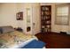 Cozy bedroom with hardwood floors, a comfortable bed, and built-in bookshelves for ample storage at 1013 Green St, Durham, NC 27701