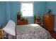 Comfortable bedroom with light blue walls, hardwood floors, and a window that lets in natural light at 1013 Green St, Durham, NC 27701