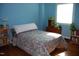 Bright bedroom with hardwood floors, blue walls, and a window that fills the space with natural light at 1013 Green St, Durham, NC 27701