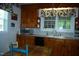 Classic eat-in kitchen featuring wood cabinetry, laminate counters, and a double basin sink under a window at 1013 Green St, Durham, NC 27701