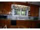 Charming eat-in kitchen featuring wood cabinetry, laminate counters, and a double basin sink under a window at 1013 Green St, Durham, NC 27701