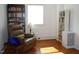 Living room featuring hardwood floors, a recliner, and built-in bookshelves for a cozy and organized space at 1013 Green St, Durham, NC 27701