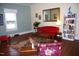 Cozy living room featuring hardwood floors, natural light, and vibrant red sofa at 1013 Green St, Durham, NC 27701