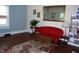 Cozy living room featuring hardwood floors, natural light, and vibrant red sofa at 1013 Green St, Durham, NC 27701