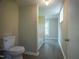 Bright bathroom featuring a toilet, tiled shower, and a window offering natural light at 1015 Cross Link Rd, Raleigh, NC 27610