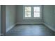 Bedroom view featuring neutral walls, modern flooring, and large double windows at 1015 Cross Link Rd, Raleigh, NC 27610