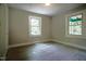 This bedroom offers ample natural light and a neutral color palette with hardwood floors at 1015 Cross Link Rd, Raleigh, NC 27610