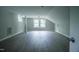 Large bonus room with gray vinyl flooring, two windows, and neutral paint at 1015 Cross Link Rd, Raleigh, NC 27610