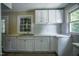 Kitchen featuring white cabinets, and a corner countertop, providing ample storage at 1015 Cross Link Rd, Raleigh, NC 27610