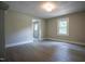 An open living room offers modern light fixtures and hardwood floors plus a view of the entry hall at 1015 Cross Link Rd, Raleigh, NC 27610