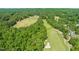 Picturesque aerial showing a golf course nestled in lush greenery, offering a scenic and recreational backdrop at 1046 Covered Bridge Trl, Chapel Hill, NC 27517