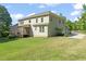 View of back of home with screened porch and spacious, green backyard with mature trees at 1046 Covered Bridge Trl, Chapel Hill, NC 27517