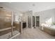 Bathroom featuring tiled walk-in shower, soaking tub, granite topped vanity and walk-in closet at 1046 Covered Bridge Trl, Chapel Hill, NC 27517