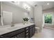 Bright bathroom with a large mirror, sleek vanity, and abundant natural light from the nearby window at 1046 Covered Bridge Trl, Chapel Hill, NC 27517