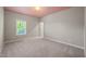 Spacious bedroom featuring neutral walls, soft carpeting, and ample natural light streaming through a large window at 1046 Covered Bridge Trl, Chapel Hill, NC 27517