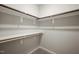 Walk in closet with multiple shelves and hanging poles at 1046 Covered Bridge Trl, Chapel Hill, NC 27517