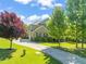 Beautiful two-story home boasts a manicured lawn, a long driveway, and mature trees for added curb appeal at 1046 Covered Bridge Trl, Chapel Hill, NC 27517