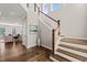 Elegant foyer with hardwood floors, wooden staircase, and high ceilings providing natural light at 1046 Covered Bridge Trl, Chapel Hill, NC 27517