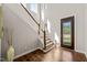 Bright foyer features hardwood floors, staircase with wood railing and decorative front door at 1046 Covered Bridge Trl, Chapel Hill, NC 27517