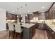 Spacious kitchen with a large center island, granite countertops, and dark wood cabinetry at 1046 Covered Bridge Trl, Chapel Hill, NC 27517