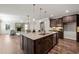 Kitchen island with sink, granite counters, and view to fireplace at 1046 Covered Bridge Trl, Chapel Hill, NC 27517