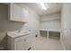 Laundry room with a sink, cabinets, and a folding table at 1046 Covered Bridge Trl, Chapel Hill, NC 27517