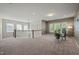 A spacious loft area with large windows offering natural light and neutral carpeting at 1046 Covered Bridge Trl, Chapel Hill, NC 27517
