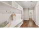 Mudroom with wainscoting, bench, storage cubbies and hardwood flooring at 1046 Covered Bridge Trl, Chapel Hill, NC 27517