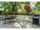 Relax on the back deck with a dining area and a grill, perfect for outdoor entertaining in a lush setting at 105 Kenmont Dr, Holly Springs, NC 27540