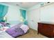 Comfortable bedroom with two windows with curtains, a ceiling fan, and a dresser at 105 Kenmont Dr, Holly Springs, NC 27540