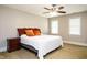 Bedroom with ceiling fan, neutral walls, carpet, and bright windows at 105 Kenmont Dr, Holly Springs, NC 27540