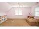 Cozy bedroom featuring a comfortable chaise lounge and built in shelving at 105 Kenmont Dr, Holly Springs, NC 27540