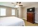 Bedroom with carpet, ceiling fan, and bedside table with drawers at 105 Kenmont Dr, Holly Springs, NC 27540