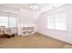 Bright bedroom featuring a comfortable rocking chair, shelf, and a ceiling fan at 105 Kenmont Dr, Holly Springs, NC 27540