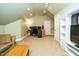 Bonus room with vaulted ceiling, entertainment center, and office space with desk and monitors at 105 Kenmont Dr, Holly Springs, NC 27540