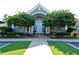 Inviting clubhouse entrance framed by mature trees and manicured landscaping at 105 Kenmont Dr, Holly Springs, NC 27540