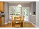 Bright dining area with natural light and views of backyard at 105 Kenmont Dr, Holly Springs, NC 27540