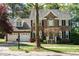 Charming brick two-story home with a two-car garage, black shutters, and well-maintained landscaping at 105 Kenmont Dr, Holly Springs, NC 27540