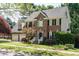 Charming brick two-story home with a two-car garage, black shutters, and well-maintained landscaping at 105 Kenmont Dr, Holly Springs, NC 27540