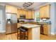 Kitchen featuring stainless appliances, granite countertops, and a center island with seating at 105 Kenmont Dr, Holly Springs, NC 27540