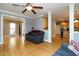 Open living room with hardwood floors, crown molding and neutral paint at 105 Kenmont Dr, Holly Springs, NC 27540