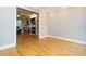 Bright room featuring hardwood floors, neutral walls and a fireplace in the background at 105 Kenmont Dr, Holly Springs, NC 27540
