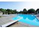 The sparkling blue swimming pool has ample seating surrounding it, perfect for relaxing at 105 Kenmont Dr, Holly Springs, NC 27540