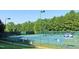 Well-maintained tennis courts surrounded by lush greenery, ideal for sports enthusiasts at 105 Kenmont Dr, Holly Springs, NC 27540